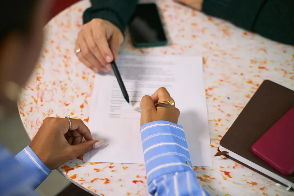 People reviewing documents during a birth certificate translation process